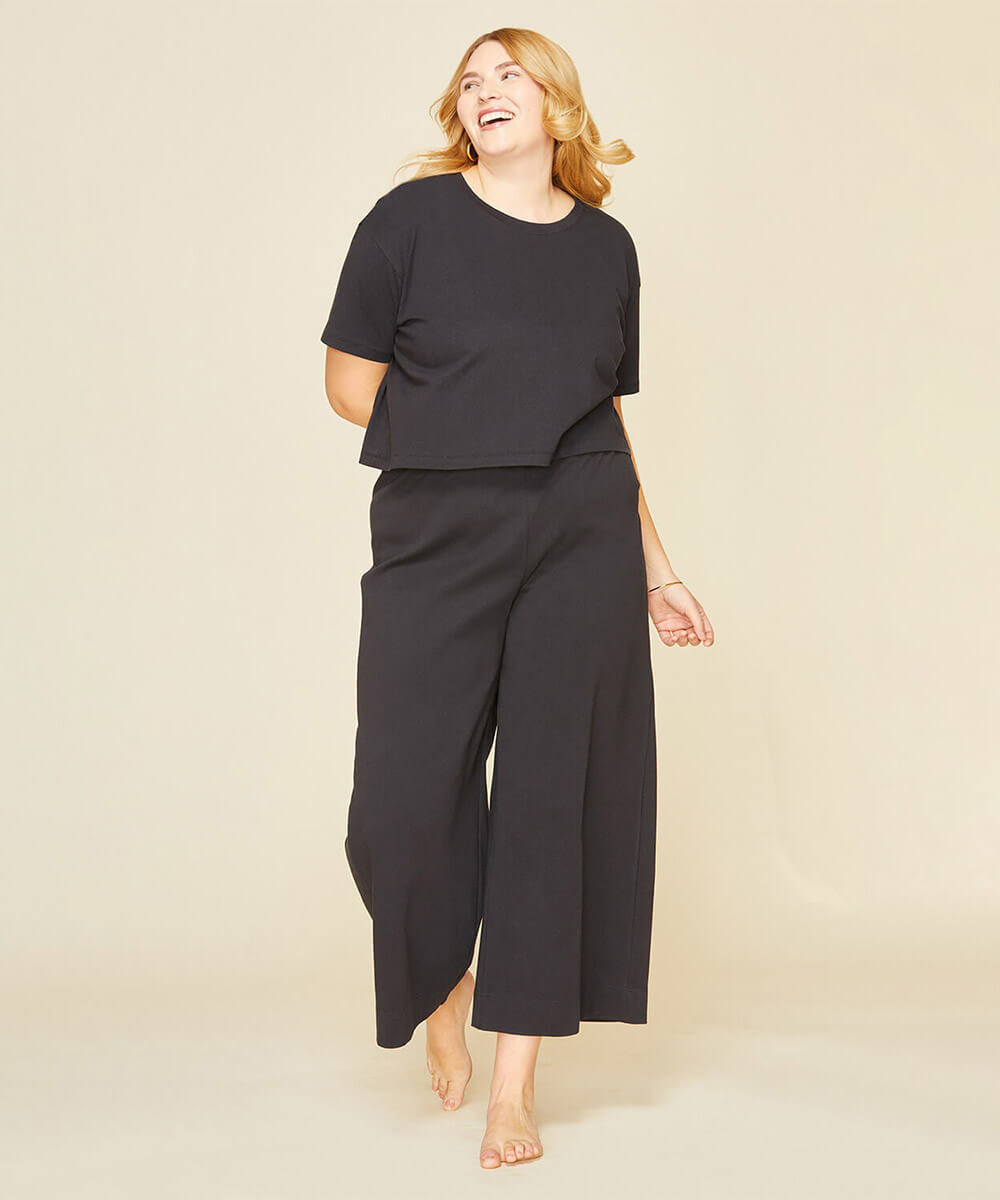 Woman wearing the boxy tee in graphite gray and wide leg pant in graphite gray color.