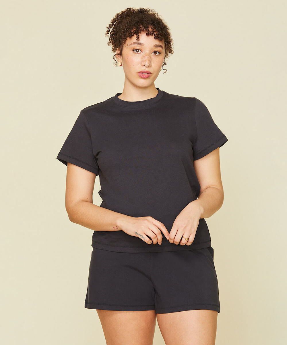Woman wearing the classic tee and soft shorts in graphite gray color.