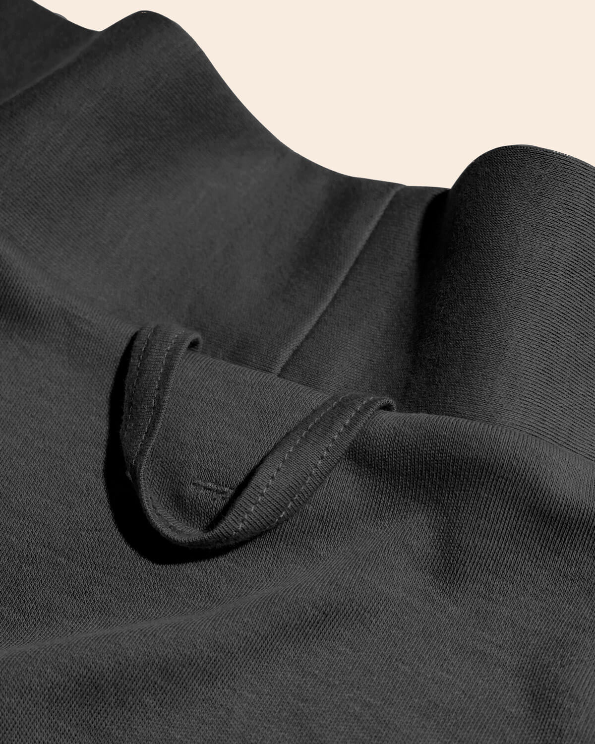 A close up shot showing the hook of the essential robe in graphite gray color.
