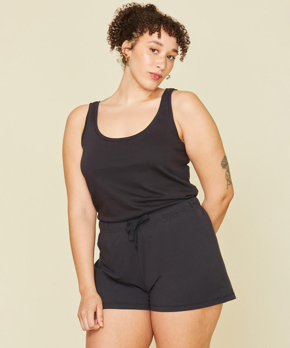 Woman wearing the easy tank and soft shorts in graphite gray color.