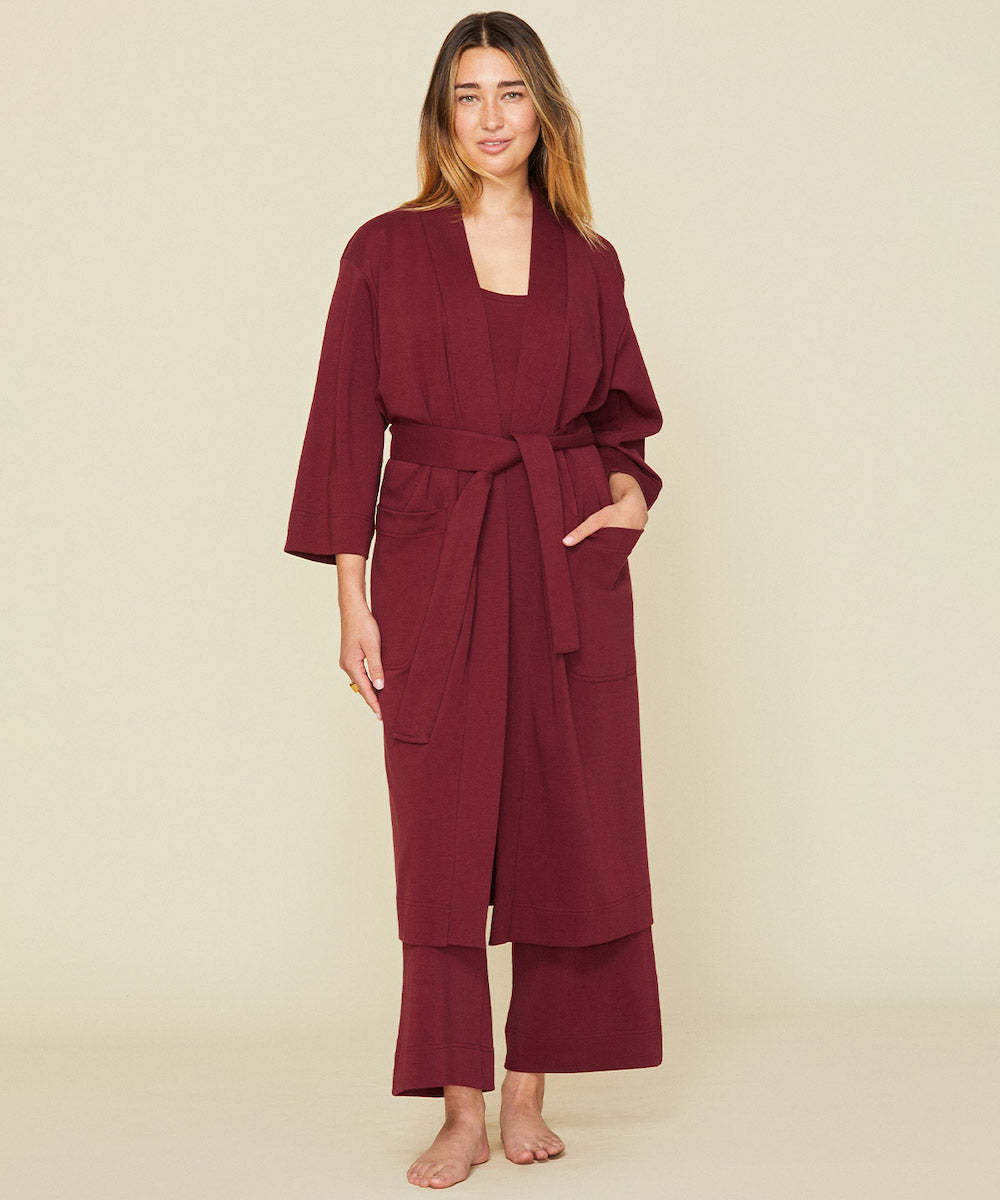 Woman wearing the essential robe in garnet red color 