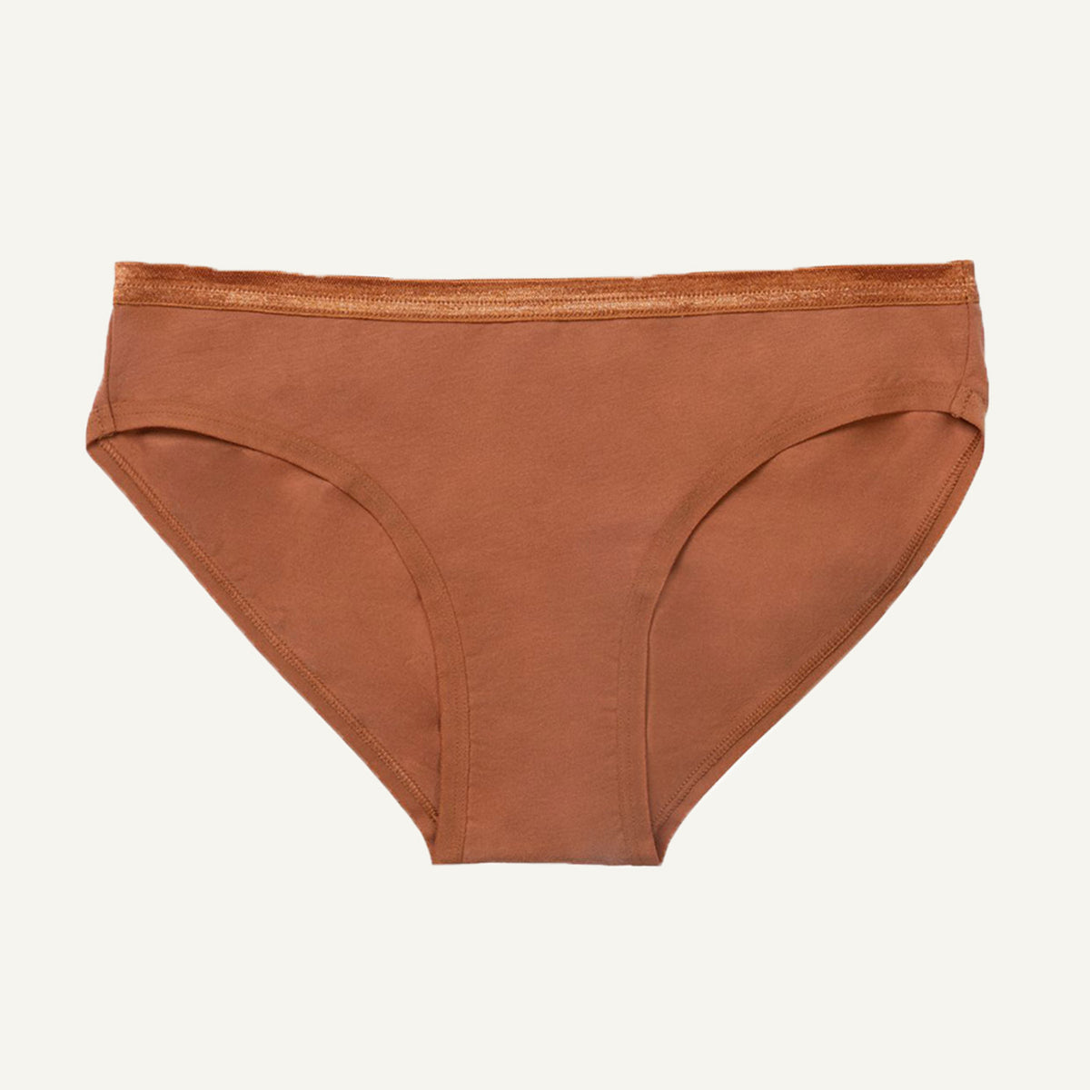 A low-rise organic cotton brief in a spice orange color, displayed against a white background.