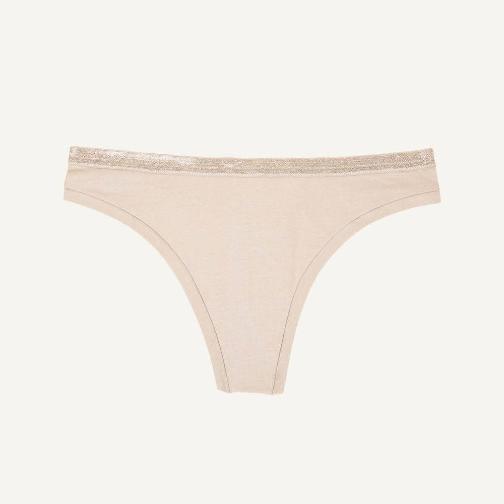 A low rise thong in stone beige color.
