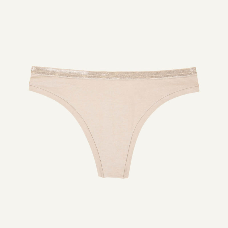 A low rise thong in stone beige color.