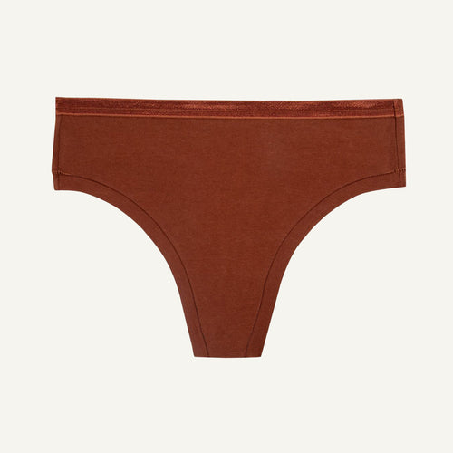 A mid-rise cacao brown thong underwear against a solid background.