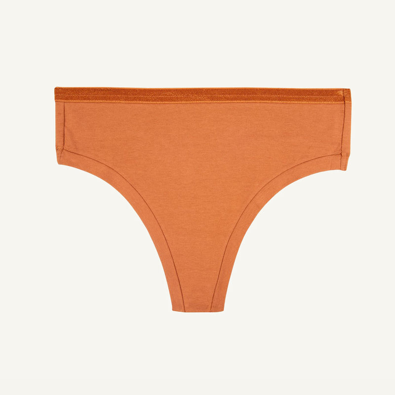 A spice orange mid-rise thong underwear against a white background