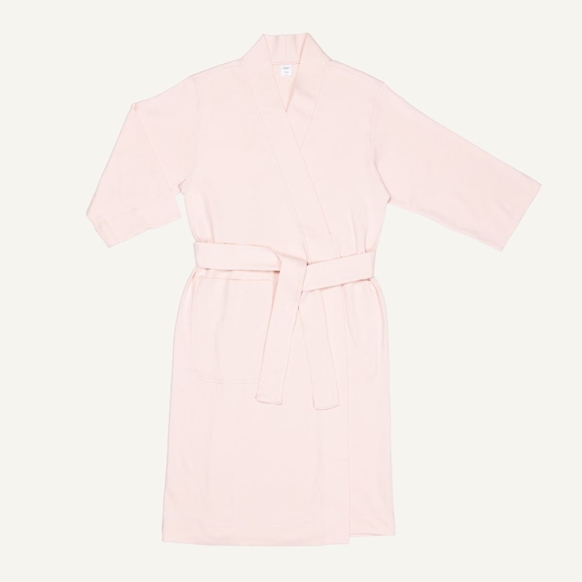 A light pink quartz organic cotton essential robe with 3/4 sleeves and a half-calf length.