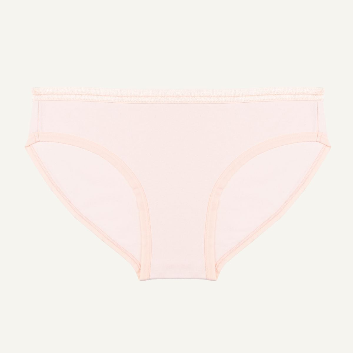 A low-rise brief in a light pink quartz color made from organic cotton.