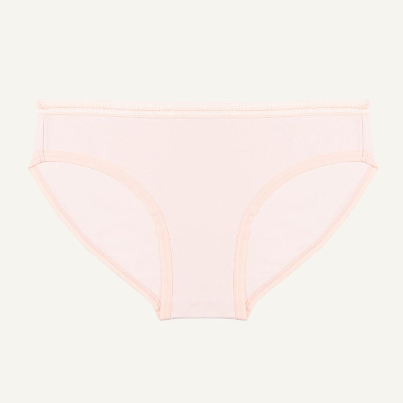 A low-rise brief in a light pink quartz color made from organic cotton.