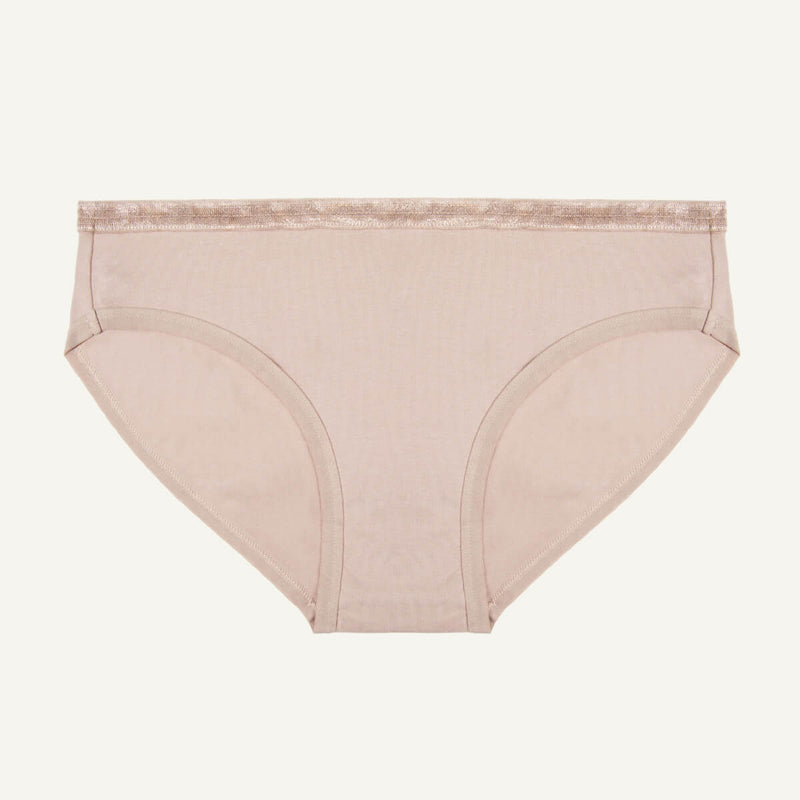 A low-rise brief in stone color made from organic cotton.