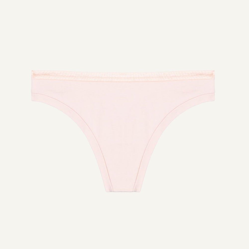 A low-rise organic cotton thong in a light pink quartz color.