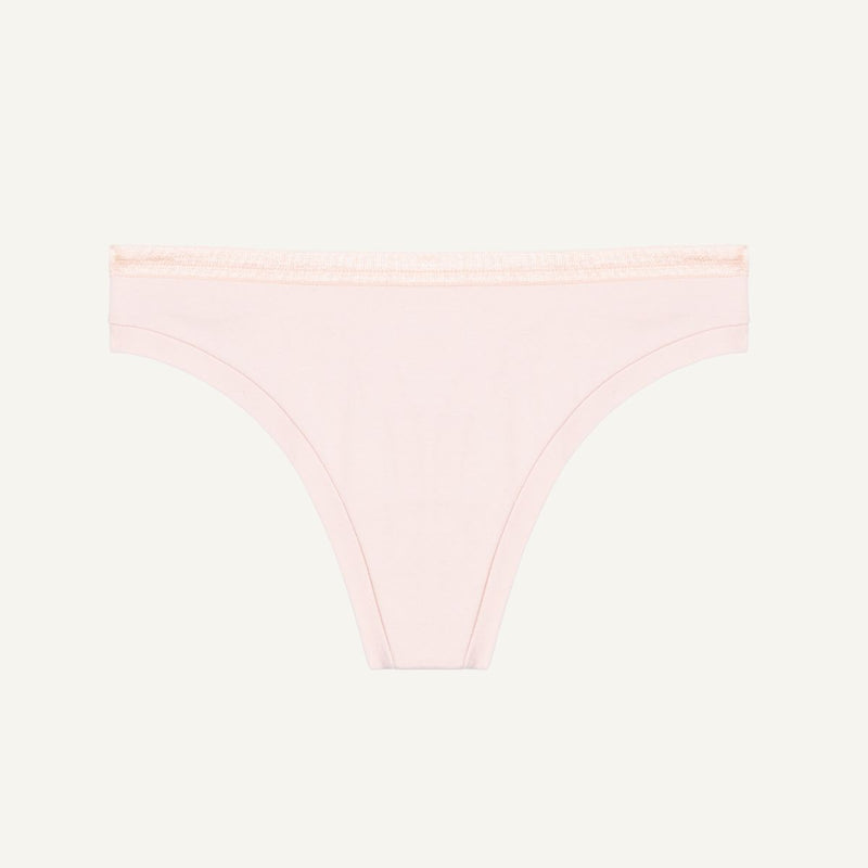 A low-rise organic cotton thong in a light pink quartz color.