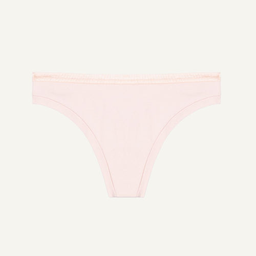 A low-rise organic cotton thong in a light pink quartz color.