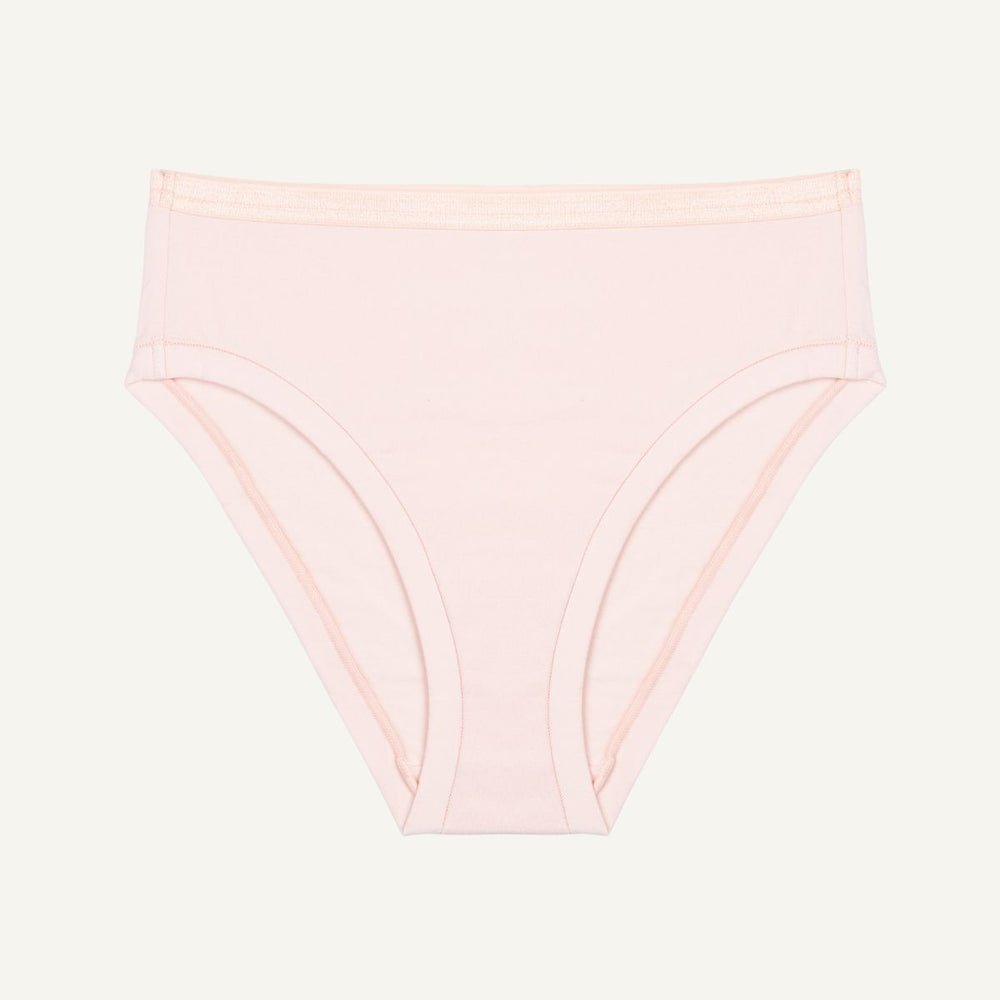 A mid-rise bikini brief in a light pink quartz color made from organic cotton.
