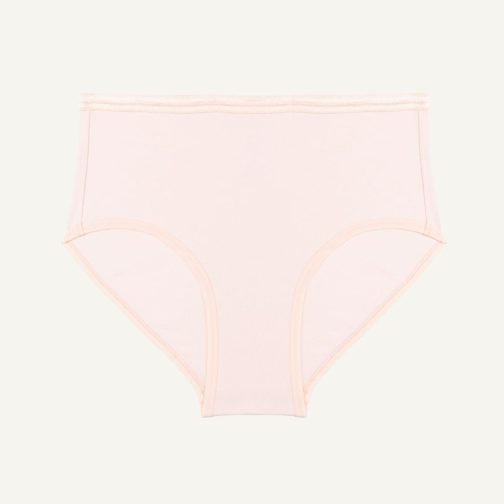 A mid-rise, organic cotton brief in a light pink quartz color, with an elastic waistband.