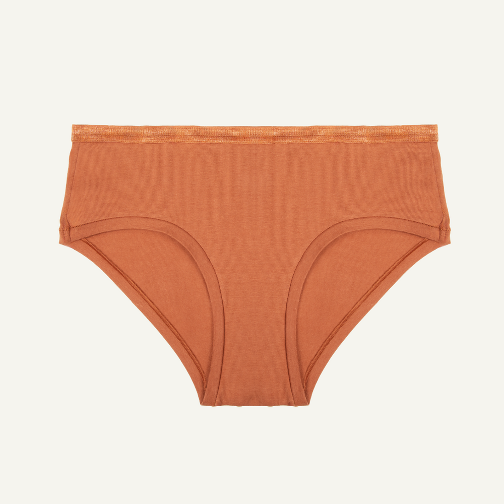 An organic cotton mid-rise hipster underwear in a spice color.