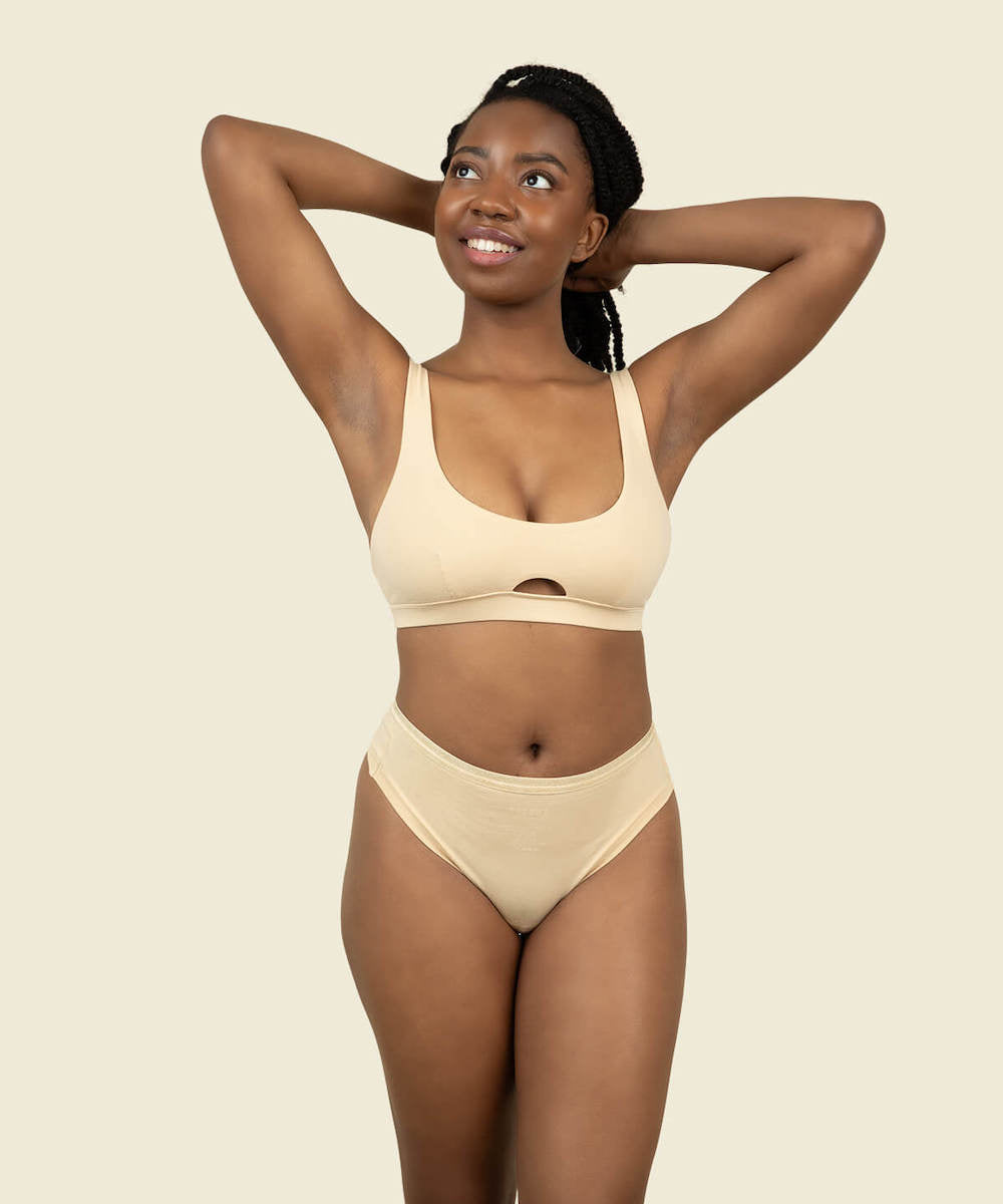 Woman wearing the mid rise thong in wheat color and soft keyhole bra in wheat color.