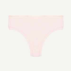 Organic cotton mid-rise thong in a quartz light pink color.