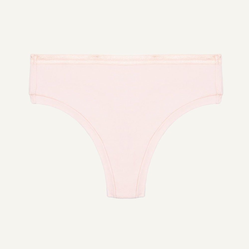 Organic cotton mid-rise thong in a quartz light pink color.