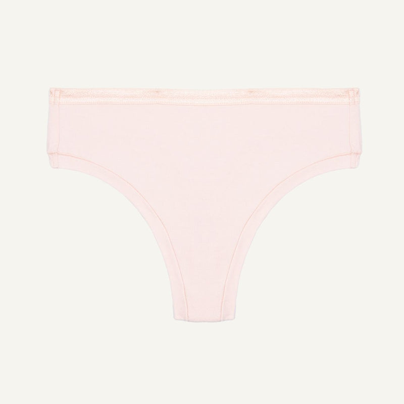 Organic cotton mid-rise thong in a quartz light pink color.