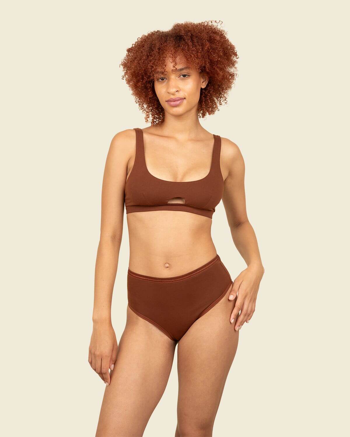 Woman wearing organic cotton high-rise brief and keyhole soft bra in cacao brown color.