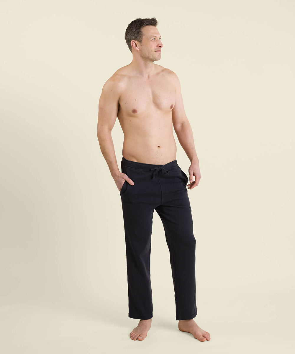 A pair of organic cotton men's house pants in a graphite color, featuring a relaxed fit, straight-leg silhouette, side pockets, and an adjustable drawstring waist.