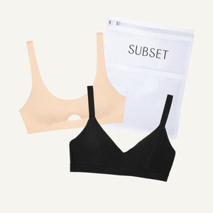 Black and beige bras with a white pouch labeled 'SUBSET' on a light gray background