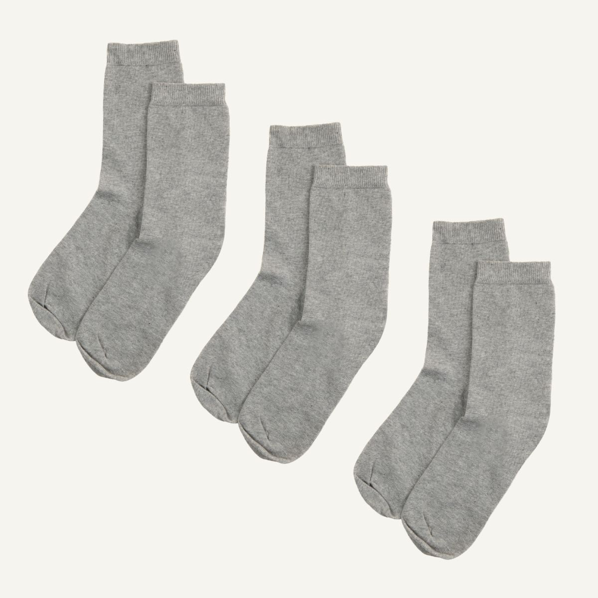 Three sets of gray organic cotton crew socks.