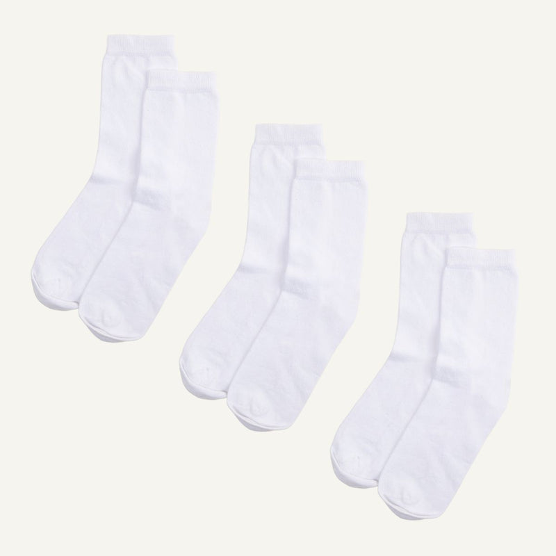 Three pairs of white organic cotton crew socks.