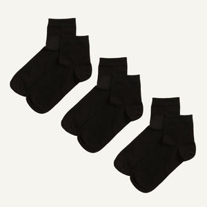 Three pairs of black organic cotton quarter socks.