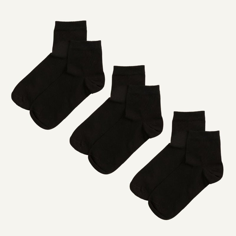Three pairs of black organic cotton quarter socks.