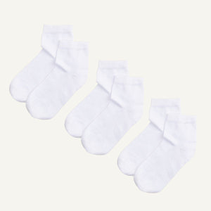 Three pairs of white organic cotton quarter socks designed to hit just above the ankle.