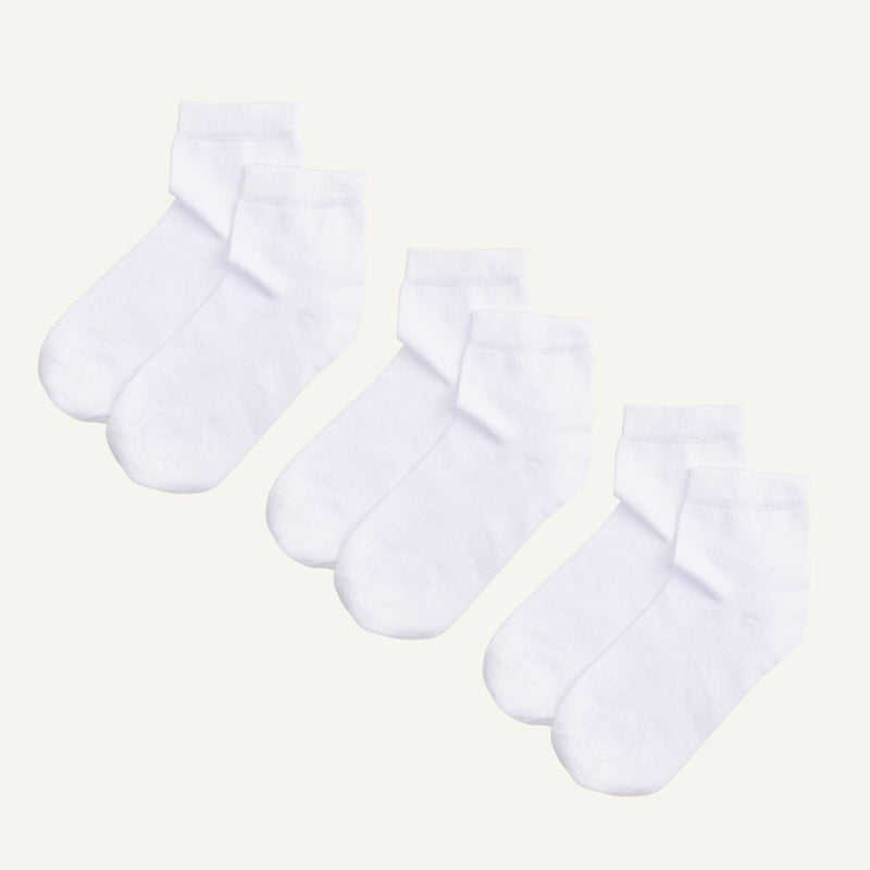 Three pairs of white organic cotton quarter socks designed to hit just above the ankle.