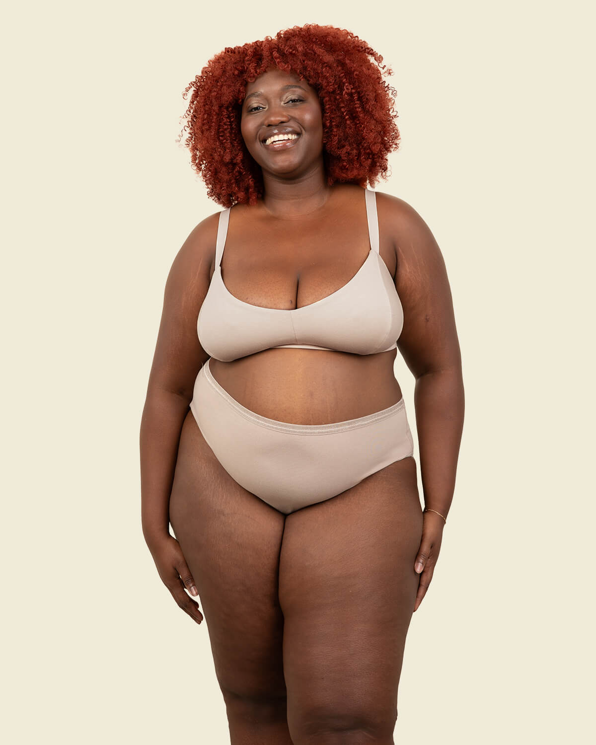Woman wearing organic cotton high rise brief underwear and triangle soft bra in stone beige color.