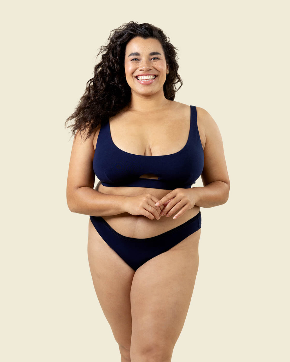 Woman in organic cotton low rise bikini underwear and triangle soft bra in marine navy blue color.