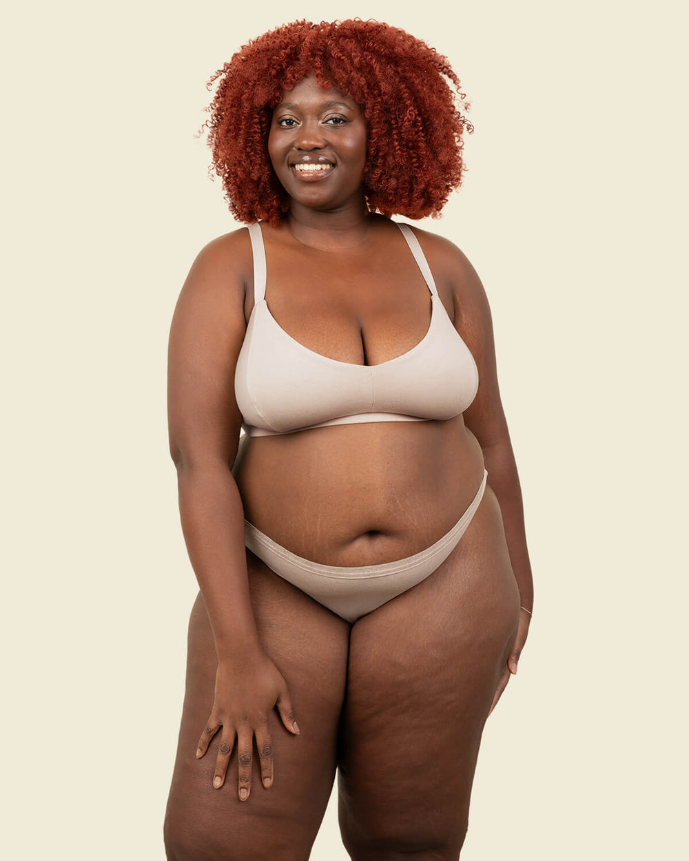 Woman in organic cotton low rise bikini underwear and triangle soft bra in stone beige color.