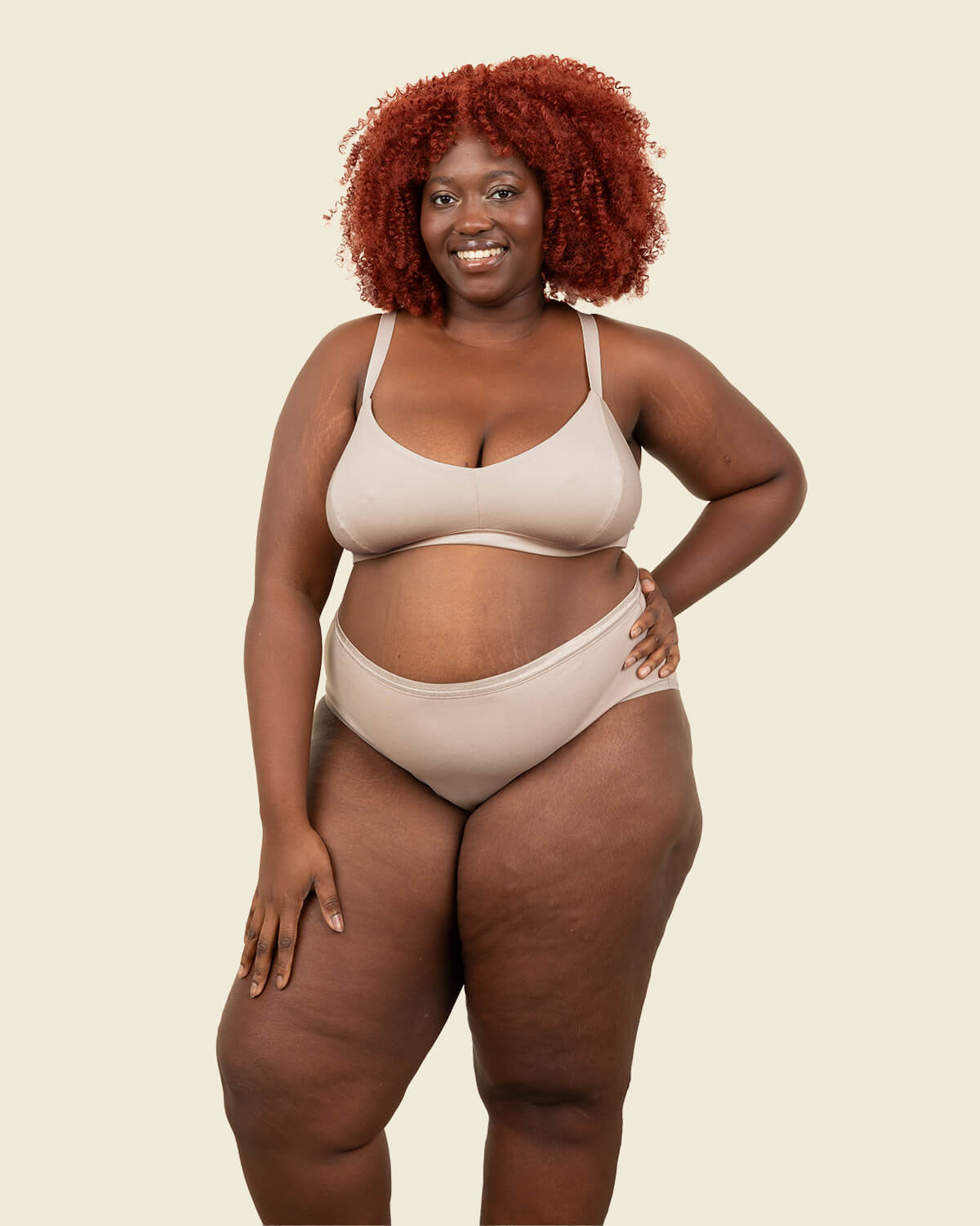 Woman wearing organic cotton mid rise brief underwear and triangle soft bra in stone beige color.