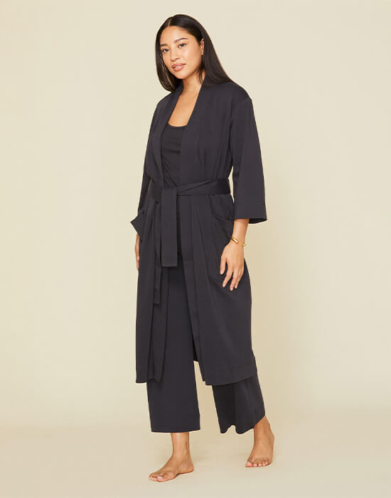 Woman wearing the essential robe in graphite gray color.