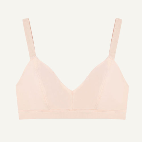 A wireless organic cotton triangle soft bra in a light pink quartz color.