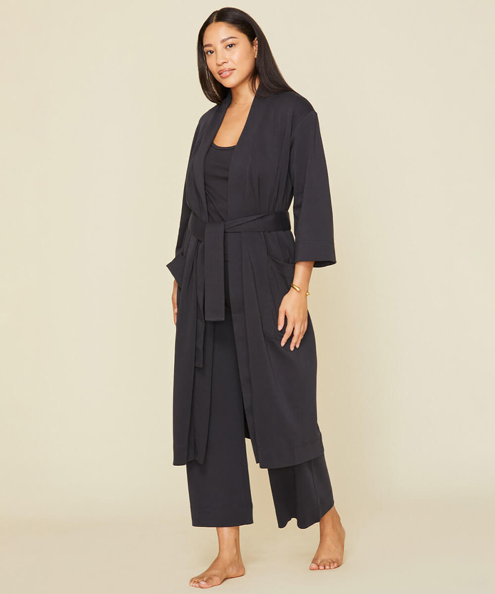 Woman wearing the essential robe in graphite gray color.
