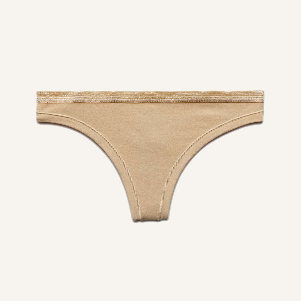 A low rise thong in wheat beige color.